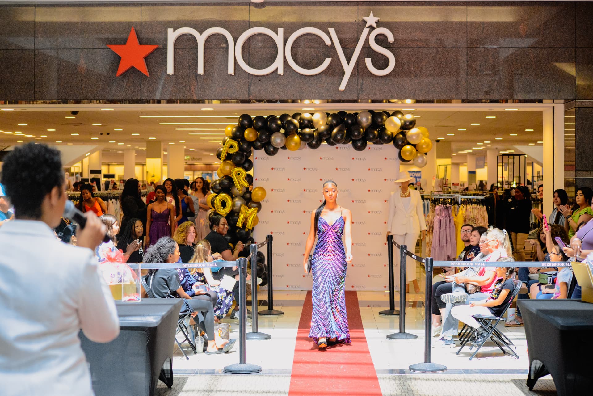 A Tenacity model walking the red-carpet runway at the Macy's 2023 Prom Fashion Show